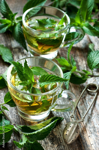 Close-up cup of mint tea with herbs