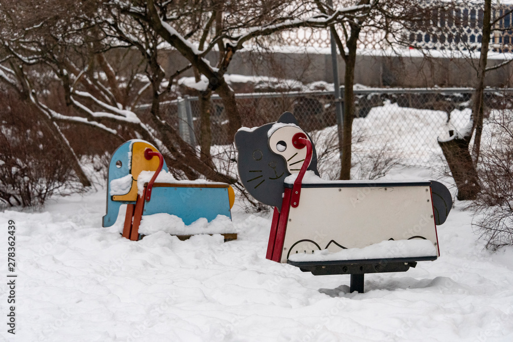 Childrens play ground animals covered in snow