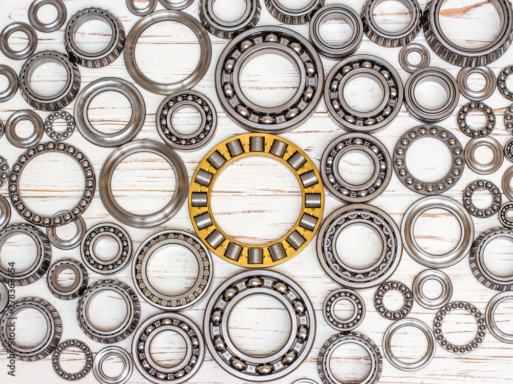 Bearings of all kinds and classifications on a white wooden background. Bearings of all kinds and classifications on a white wooden background.