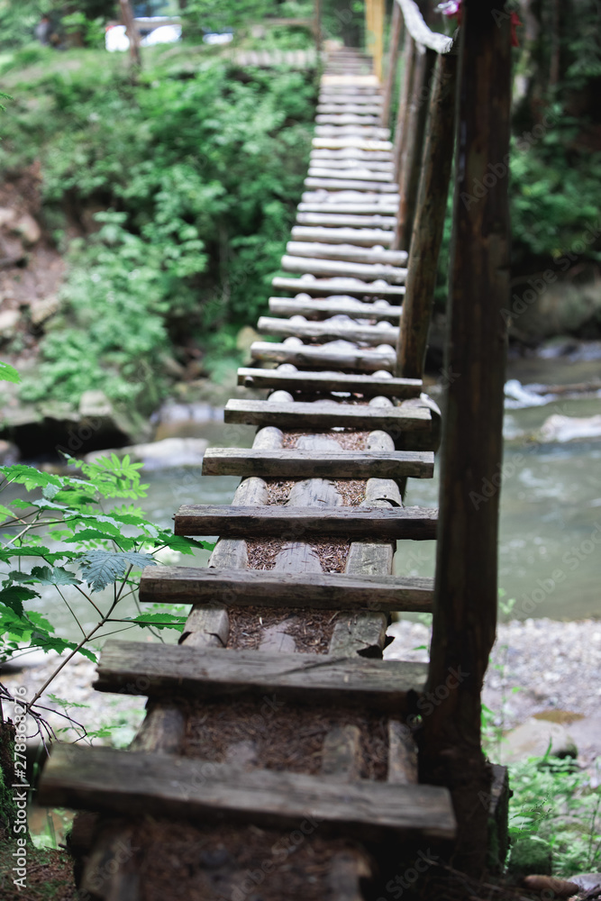 small wooden bridge cross mountain river
