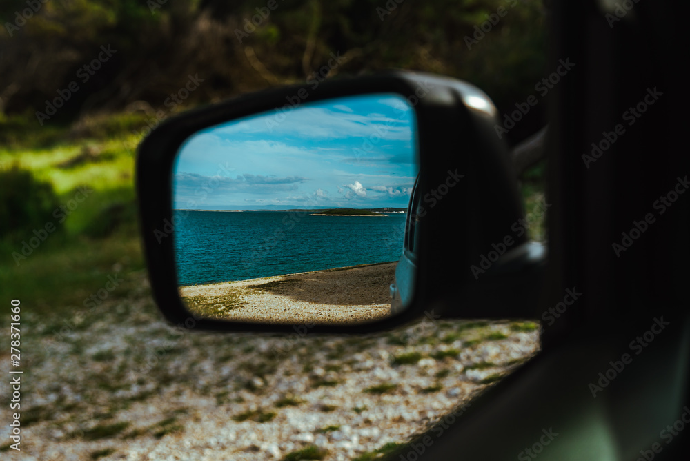 sea reflection in car rear mirror. road trip sea reflection in car rear mirror. road trip