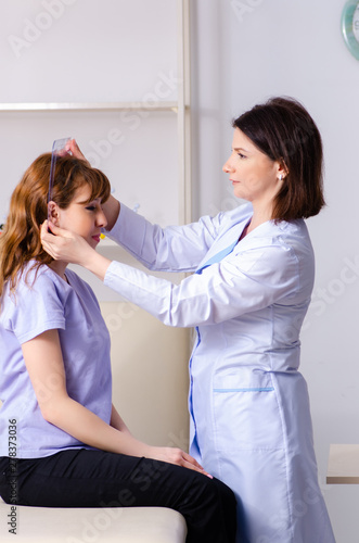 Female doctor checking patient's joint flexibility with goniomet