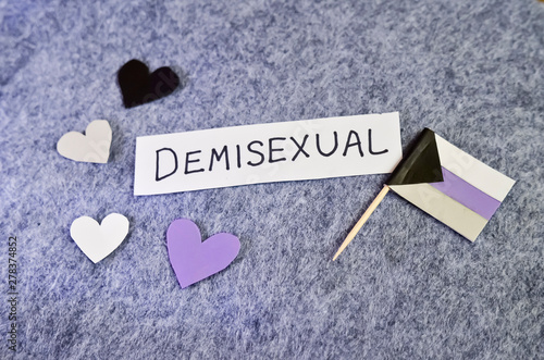 Handwritten Word Demisexual on Gray Background with Demi Flag and Hearts