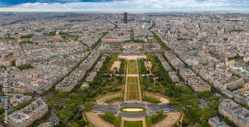 Perfect aerial panorama of the Champ de Mars park, the École Militaire building behind, the Les Invalides building complex with the golden dome and in the distance the skyscraper Tour Montparnasse.  photo