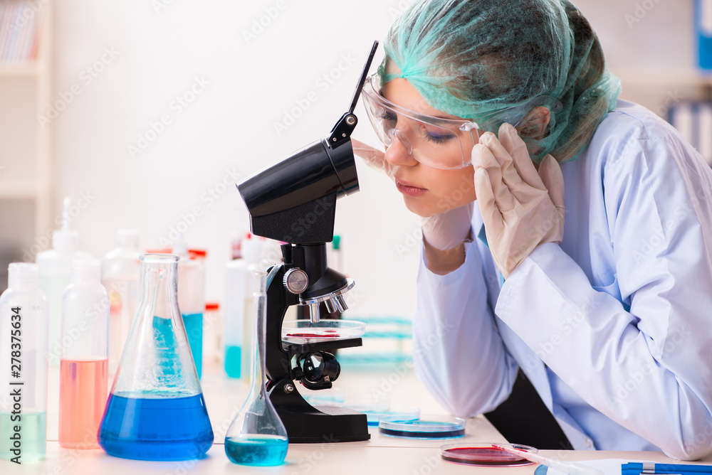 Young female chemist working in the lab Young female chemist working in the lab