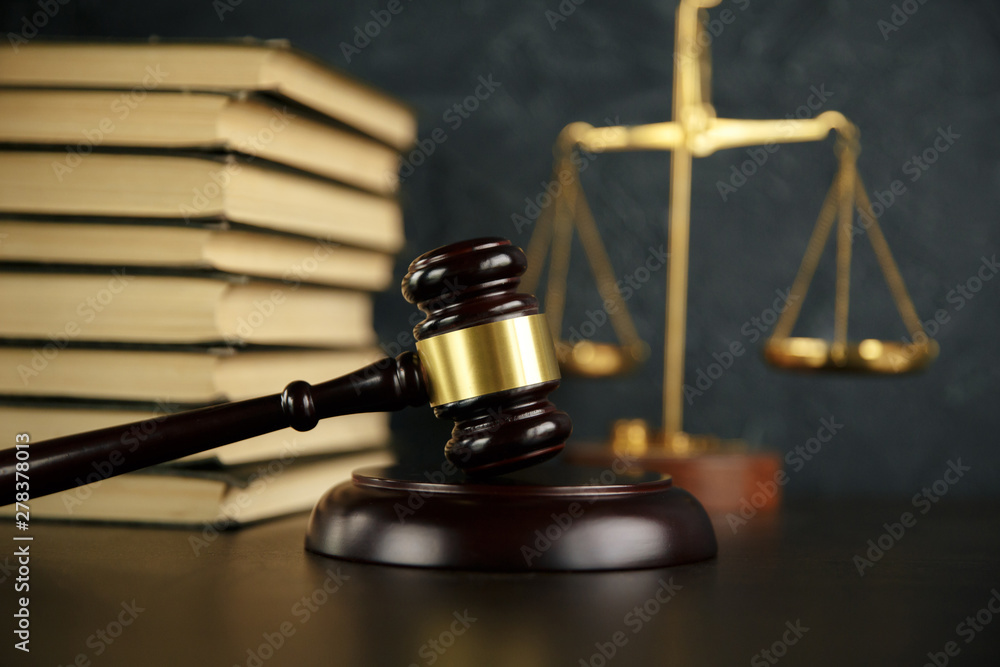 Judge gavel, scales of justice and law books in court Judge gavel, scales of justice and law books in court