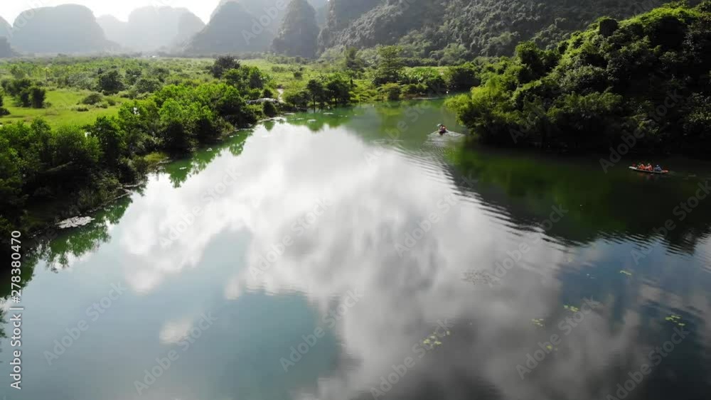 Tourists Paddling In Canoe On Green River, Ninh Binh Vietnam, Sky Water Reflection, Aerial Drone Dolly Tourists Paddling In Canoe On Green River, Ninh Binh Vietnam, Sky Water Reflection, Aerial Drone Dolly