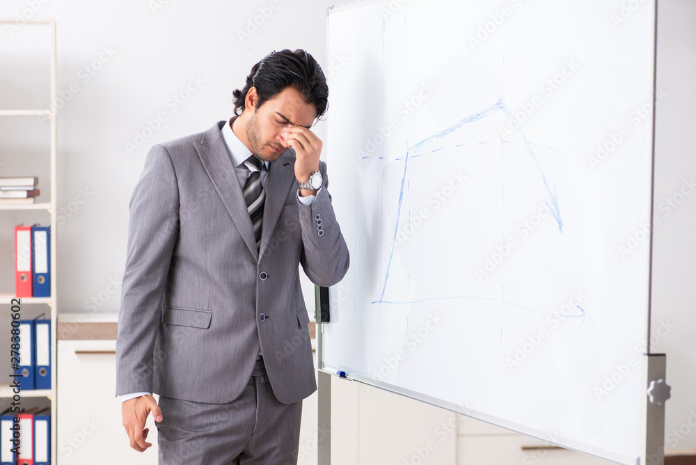 Young handsome businessman in front of whiteboard Young handsome businessman in front of whiteboard