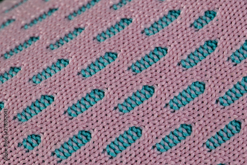 A fragment of blue and pink fabric sneaker. The texture of the material of sports shoes