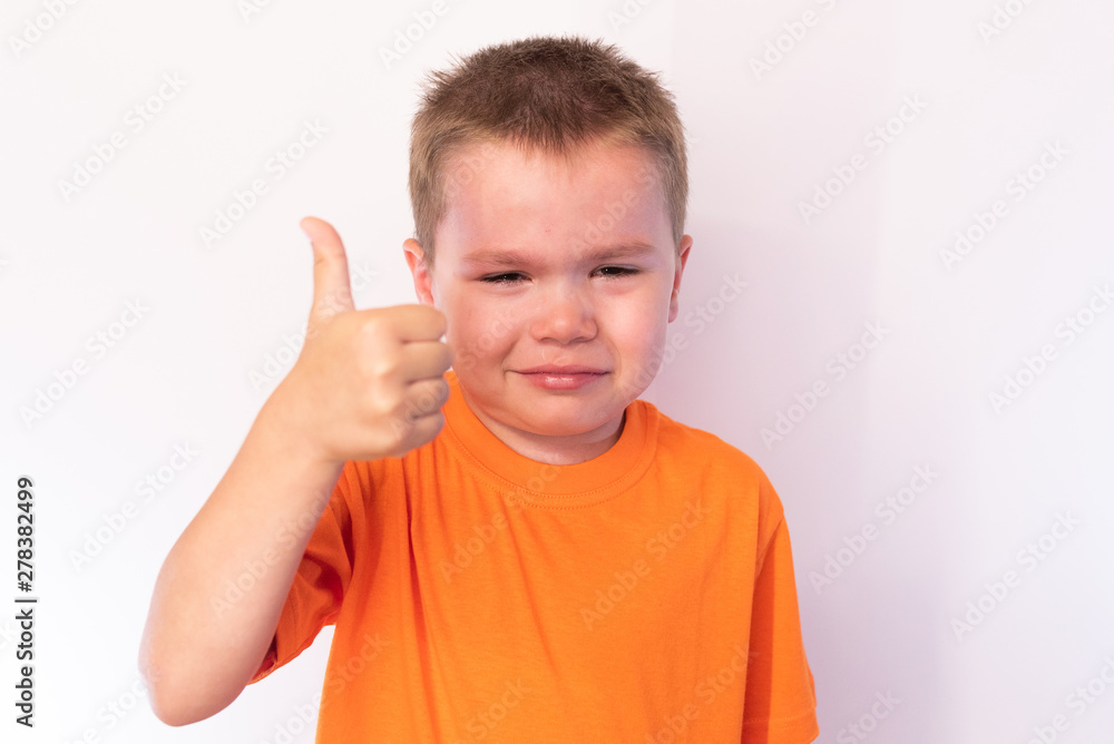 Cute little boy with tear-stained face, that shows the class, on a light background Cute little boy with tear-stained face, that shows the class, on a light background