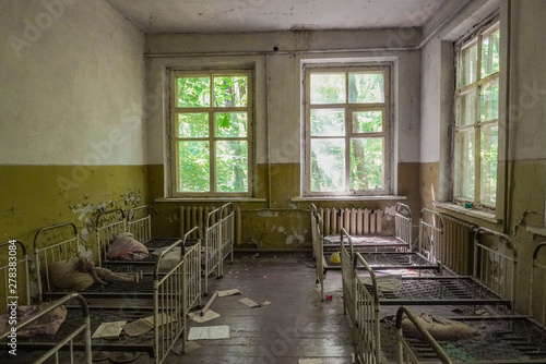 Crumbling ruins of a bedroom in a school in Pripyat, Ukraine near Chernobyl that was abandoned after the nuclear accident  photo