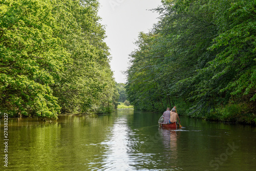 People rowing in a canoe on the river at Vestbirk, Denmark