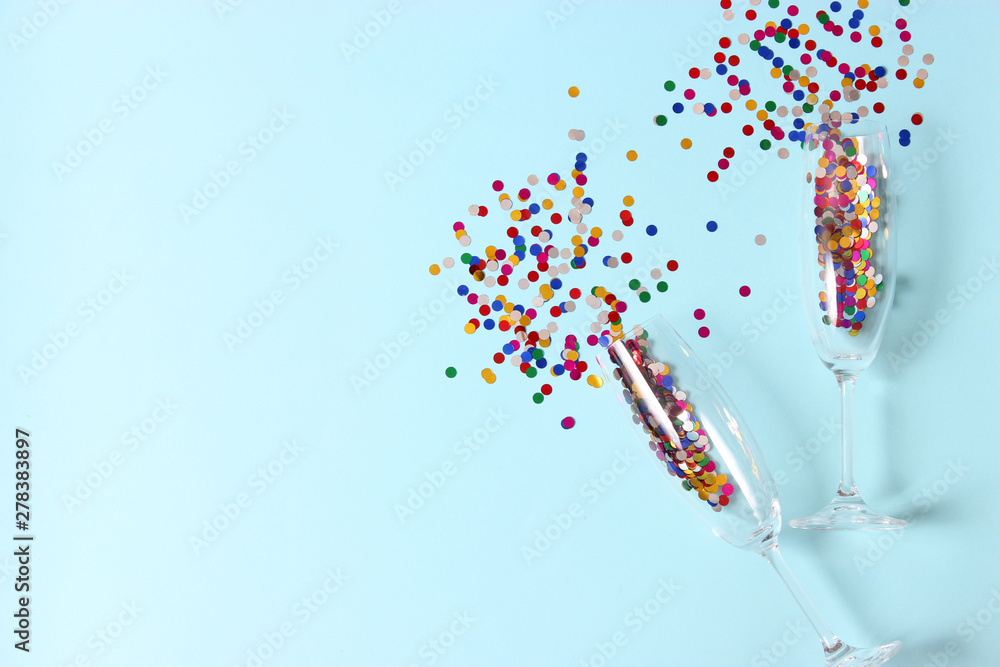 glasses and confetti on a colored background top view. glasses and confetti on a colored background top view.