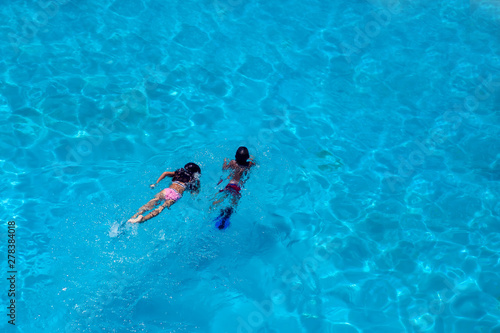Children swim in the pool. Summer and vacation concept