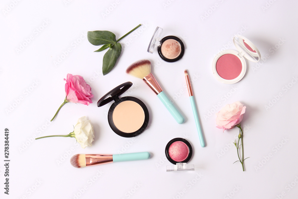 Cosmetics and flowers on a light background top view. Cosmetics and flowers on a light background top view.