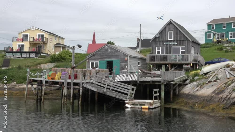 Red wooden house on stilts stands in the water of the sea bay. Red wooden house on stilts stands in the water of the sea bay.