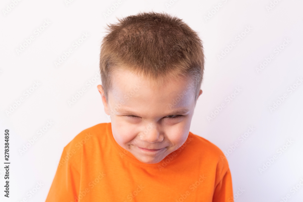 Little cute boy, looking suspiciously from under the forehead, on a light background Little cute boy, looking suspiciously from under the forehead, on a light background
