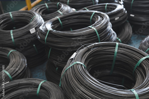 Pile of iron, metal wire rod or coil background for Construction industry. steel wire fence rolls. Steel wire tie rolls for construction and industrial. Coil of iron or steel background.