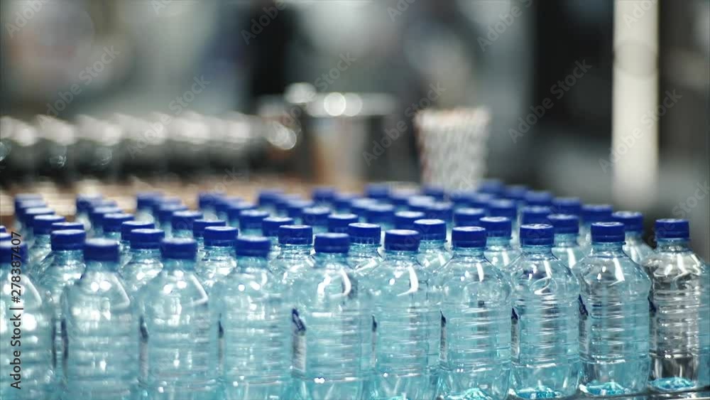 plastic bottles of water on a table plastic bottles of water on a table