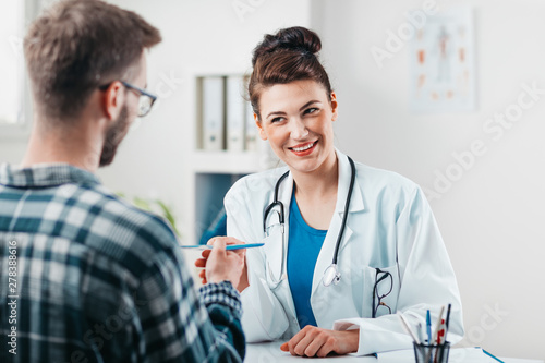 Woman Doctor prescribes medicine to Young Patient