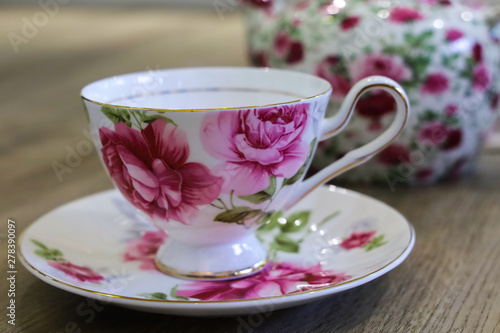 Antique floral tea set including tea pot, saucer and cup