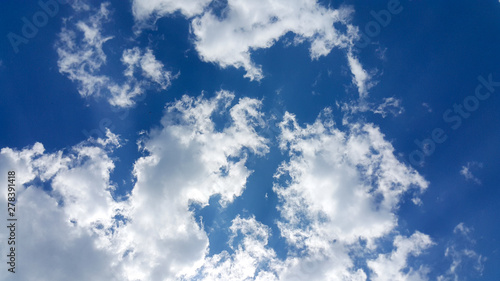 beautiful background of clouds  clearly visible lines of white clouds and blue sky  the top is a sunbeam