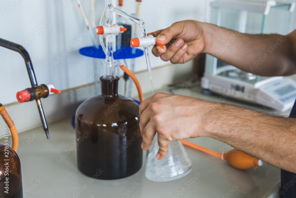 Man or male hold test tube in hands produces chemistry experiment test and research in modern chemistry lab. Man or male hold test tube in hands produces chemistry experiment test and research in modern chemistry lab.