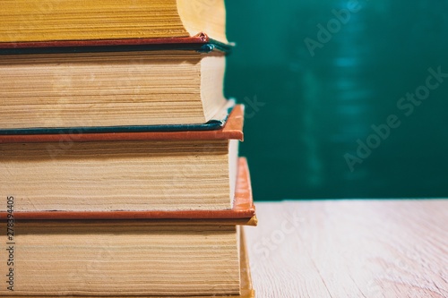 stack of books against a dark green background