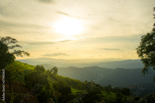 The longitudinal mountains and the setting sun and the forest on Doi Tung © Surachet