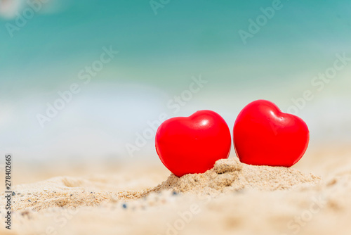 Two Hearts couple lover symbol on honeymoon day trip in tropical paradise island with banner copy space. Romantic red hearts objects on wedding anniversary for couple lover. Honeymoon tourism concept.