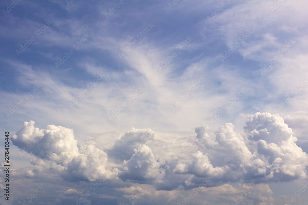 white Cumulus clouds against a bright blue sky white Cumulus clouds against a bright blue sky