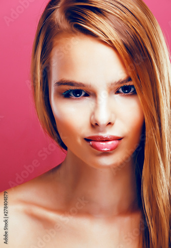 young pretty blonde real woman with hairstyle close up and makeup on pink background smiling  stylish fashion look like baby doll