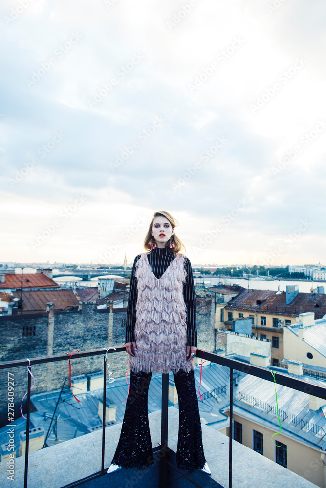 cool blond real fashion style girl posing sensual on roof top, lifestyle people concept