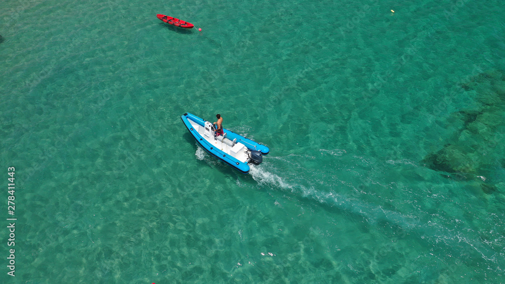 Aerial bird's eye view of inflatable rib boat cruising in high speed in turquoise clear water sea Aerial bird's eye view of inflatable rib boat cruising in high speed in turquoise clear water sea