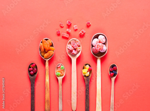 Wooden spoons with dried fruits and candied. The concept of organic products or oriental sweets.