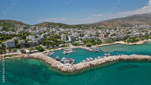 Aerial drone photo of famous seaside village of Varkiza with deep turquoise sandy beaches and clear blue sky, Athens riviera, Attica, Greece