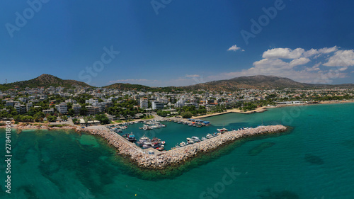 Aerial drone photo of famous seaside village of Varkiza with deep turquoise sandy beaches and clear blue sky, Athens riviera, Attica, Greece © aerial-drone