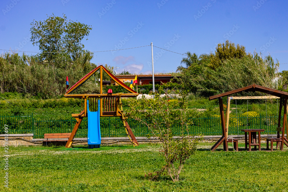 Bacoli, Naples, Italy May 25, 2019. In the park of the children's rides, the slide, the swing.