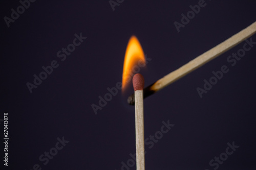 Close up Macro shot of a ignition match on a second match captured in super slow motion
