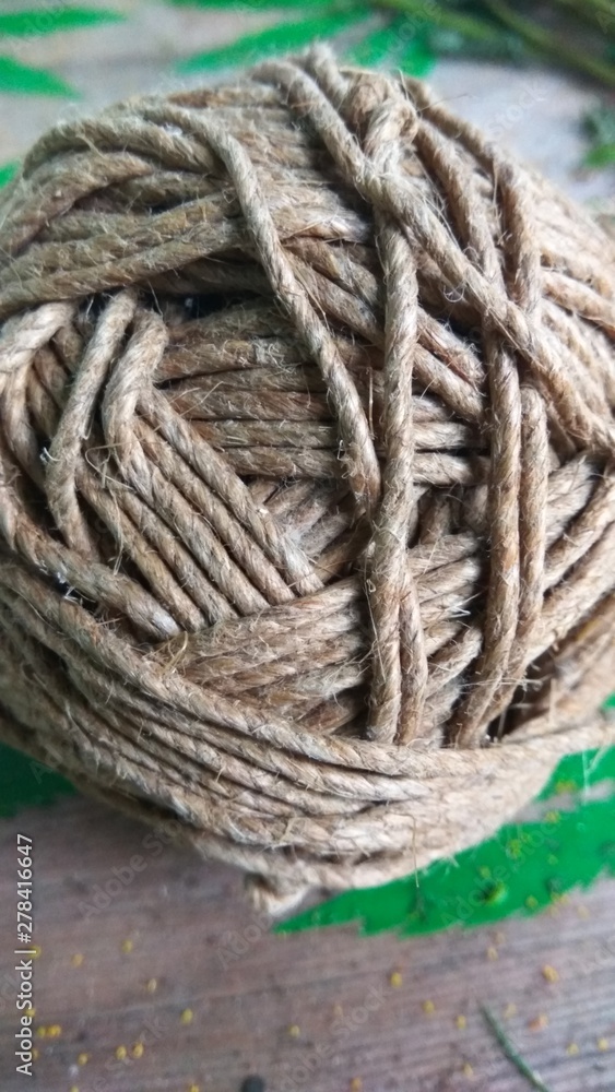 A ball of rope on a wooden table