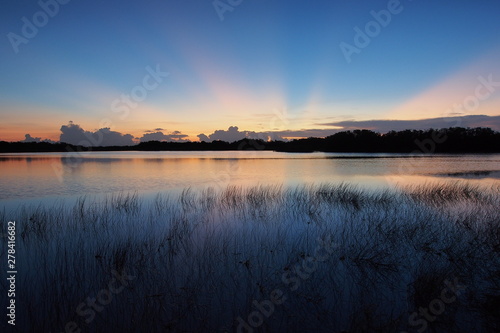 Sunrise with distinct sun rays over Nine Mile Pond in Everglades National Park  Florida.