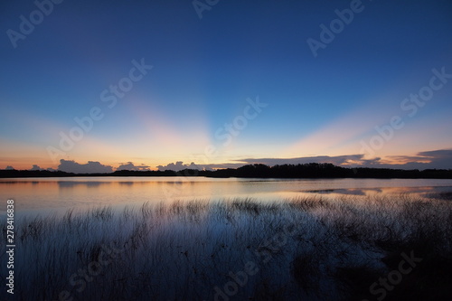 Sunrise with distinct sun rays over Nine Mile Pond in Everglades National Park, Florida.