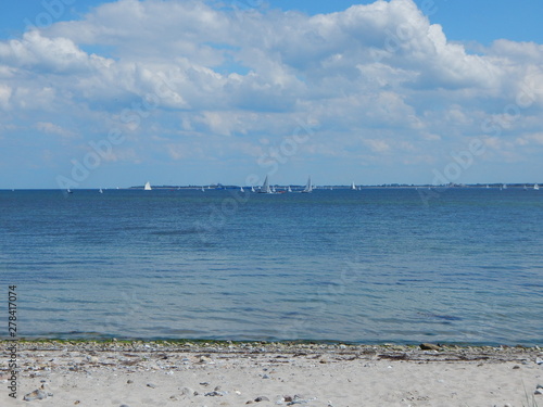 View from the beach on the sailboats in the Kiel Fjord at the Baltic Sea