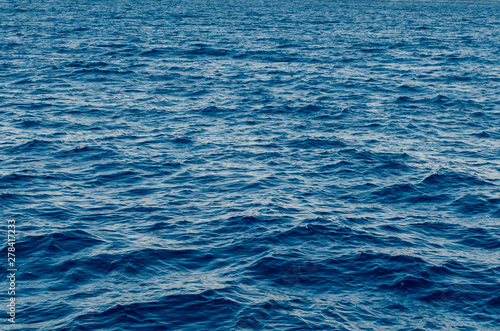 Waves on the surface of the blue sea, background texture