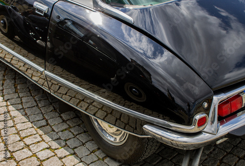 two french classic cars mirroring each other (ds and traction avant)