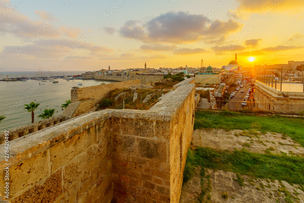 Fototapeta premium Sunset view with skyline, walls and fishing port, in Acre