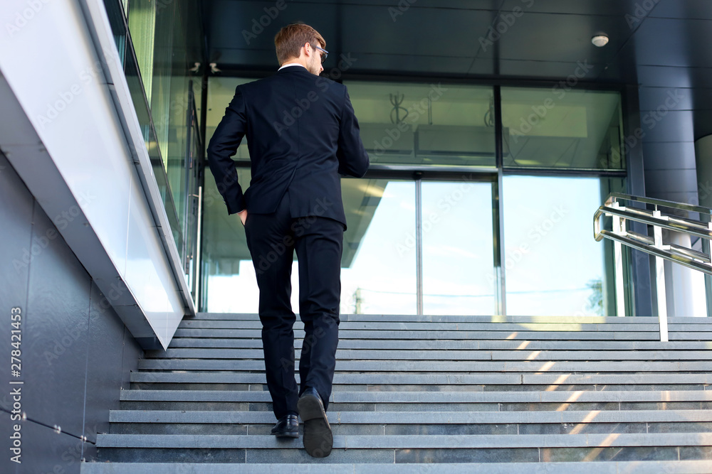 custom made wallpaper toronto digitalStylish successful businessman goes up the stairs of the office building.