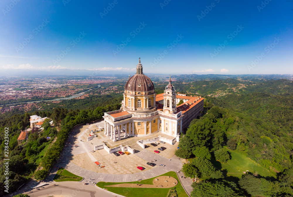 Beautifull aerial panoramic view to the famous from the drone Basilica of Superga in sunny summer day. The cathedral church located at the top of hill in italian Alps mountains. Turin, Piedmont, Italy