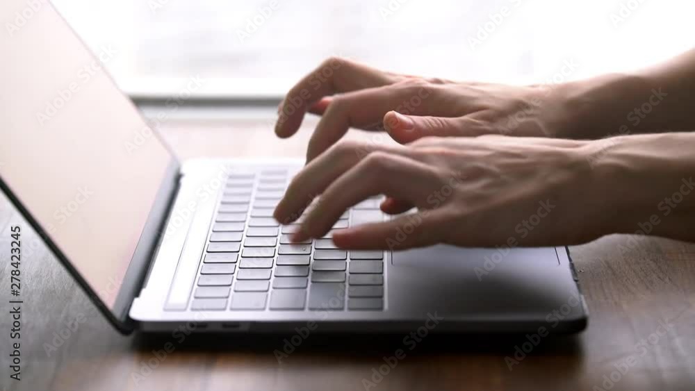 Close up hands typing on laptop computer keyboard Close up hands typing on laptop computer keyboard