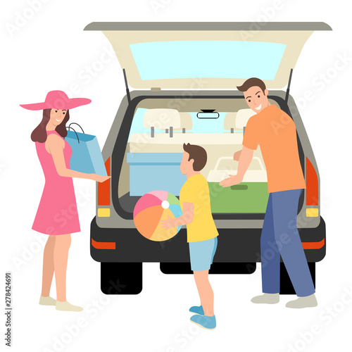 Family packing things into car trunk
